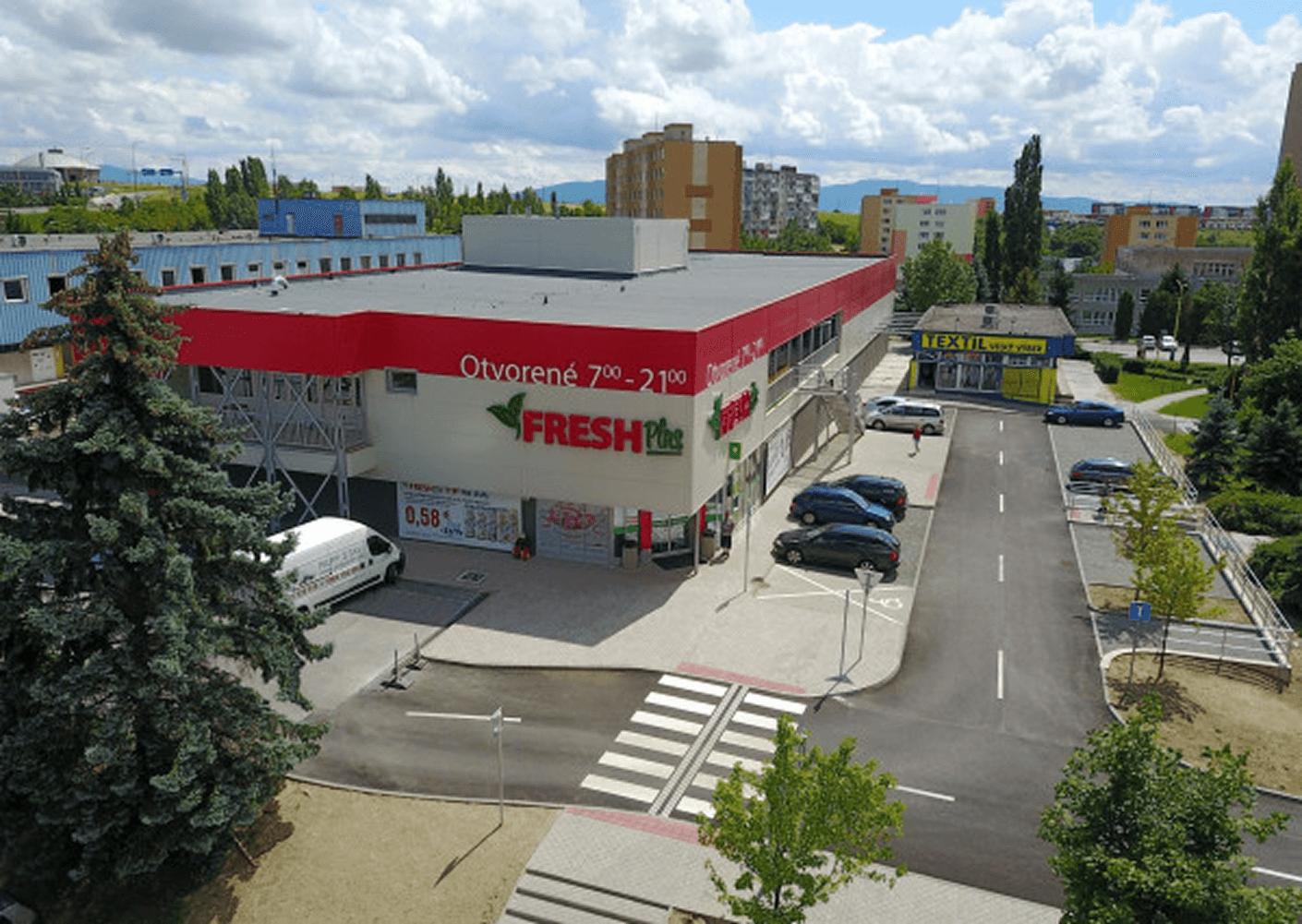 Aerial view of a Fresh Plus retail store and parking
